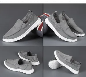 Detail view of men's grey slip-on canvas shoes with breathable side vents and white soft soles.