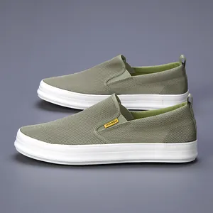 Close-up view of breathable green mesh men's slip-on casual shoes with white sole