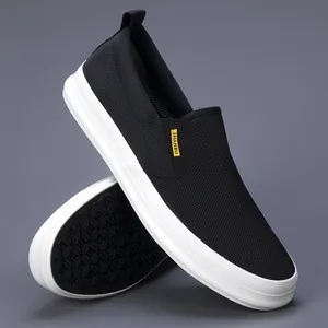 Macro view of breathable mesh texture and non-slip sole of black slip-on shoes