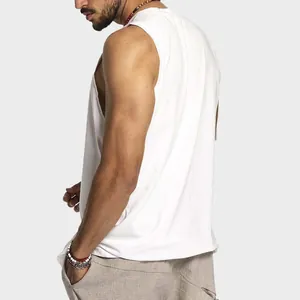 Detail of men's white sleeveless cotton vest showing relaxed fit and side profile.
