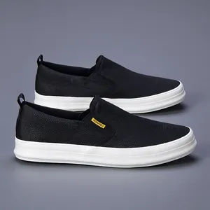 Side view of breathable black mesh slip-on sneakers for men with thick white soles