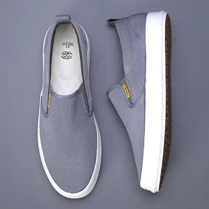 Top and side view of men's breathable grey mesh slip-on loafers with white soles