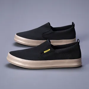 Close-up of black breathable mesh slip-on shoes with comfortable tan soles.