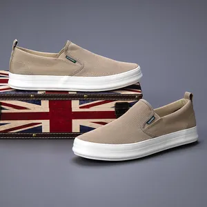 Men's breathable khaki mesh slip-on loafers on a vintage Union Jack suitcase
