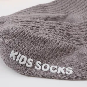Close-up of baby ribbed socks with white anti-slip silicone lettering for safety