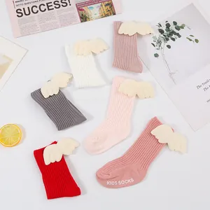 Collection of ribbed baby socks in multiple colors with plush wing decorations