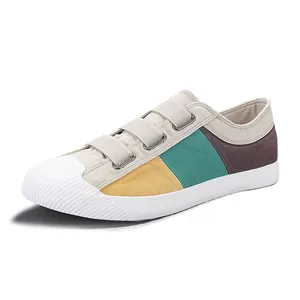 Casual men's low-top canvas shoes with tri-color side panels and velcro fasteners