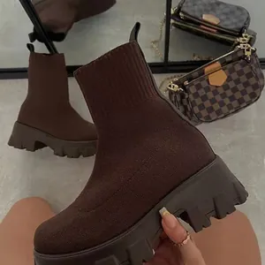Stylish brown knitted sock boots featuring thick platform lug soles and breathable fabric