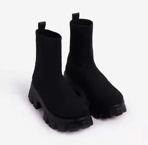 Detail of black breathable knit sock boots featuring chunky platform soles for women