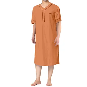 Close-up detail of men's short-sleeve peach nightgown with contrast piping