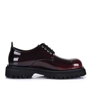 Detail side view of men's burgundy patent leather platform Derby shoes with lug sole