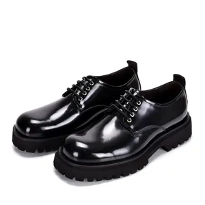Detailed view of men's glossy black leather Derby shoes with thick platform soles