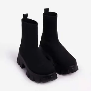 Stylish women's black knit sock boots featuring a chunky platform lug sole for casual wear