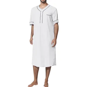 Detail of a men's loose white short sleeve thobe nightgown with elegant black piping detail