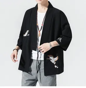 Detailed view of traditional crane embroidery on a black loose-fit Japanese style haori