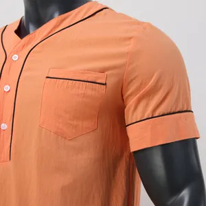 Close-up detail of orange men's sleeprobe featuring black contrast piping and buttons