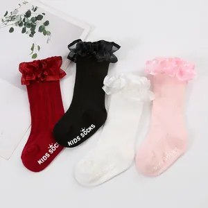 Detailed view of four pairs of baby girls ruffle socks featuring anti-slip sole grips