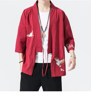 Detail view of red kimono cardigan with crane embroidery and traditional Chinese style elements