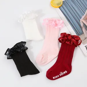 Detail of multi-colored ruffled lace princess socks with non-slip grip for baby girls