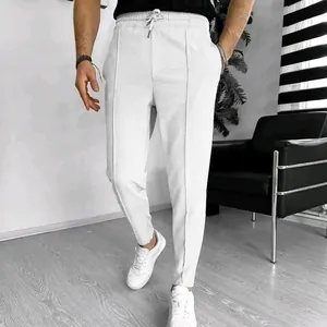 Detailed view of men's white waffle knit casual joggers with a drawstring waist.