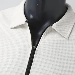 Detailed view of cream waffle knit texture and zipper on a men's polo collar jacket