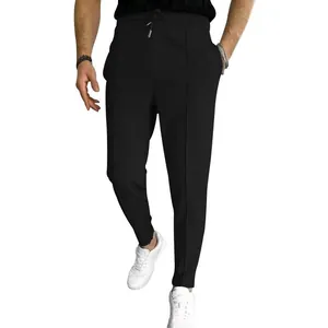 Detailed view of men's black waffle knit drawstring casual pants with white sneakers