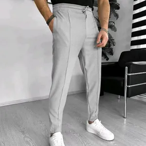 Full view of men's grey waffle knit casual trousers with drawstring waist.