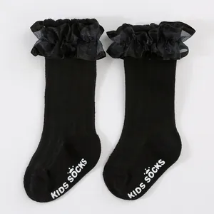 Detailed view of black kids' lace princess socks with anti-slip rubber grip lettering.