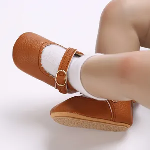 Close-up of brown baby walking shoes with scalloped edges and non-slip rubber sole