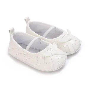 Elegant white quilted baby girl flat shoes featuring a decorative ribbon bow design