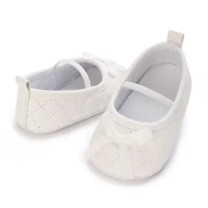 Detailed view of white quilted baby girl flat shoes featuring an elegant bow design