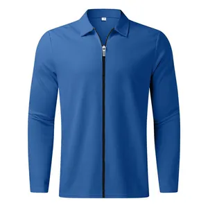 Close-up detail of the waffle-knit texture and front zipper on this blue long-sleeve polo.