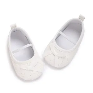 Detailed view of elegant white quilted baby pre-walker shoes with ribbon bow accents