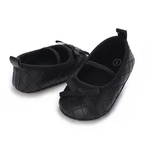 Detailed macro view of black quilted baby girl flat shoes featuring a cute bow detail
