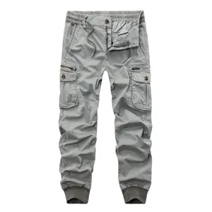 Detail view of men's casual grey cargo jogger pants with multiple pockets and drawstring.