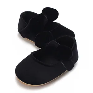 Detailed view of black velvet baby girl pre-walker shoes with a large decorative bow
