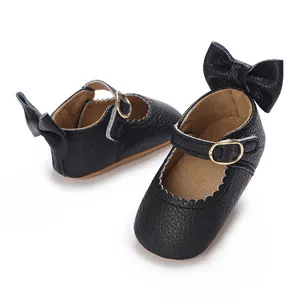 Detailed view of black leather baby girl infant shoes with elegant bow and non-slip sole