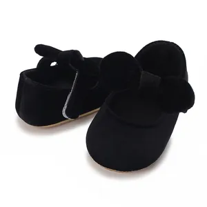 Detailed view of cute black velvet baby girl princess shoes featuring a large bow