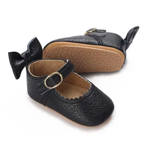 Close-up of black baby Mary Janes with bow detail and non-slip rubber sole