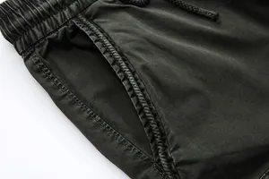 Detailed close-up of the elastic waistband and pocket on washed black casual cargo pants