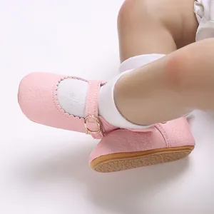 Close-up detail of pink baby girl walking shoes with anti-slip rubber sole and strap buckle