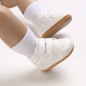 Close-up detail of white leather baby walker shoes with adjustable double velcro straps