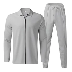 Macro view of men's light gray waffle knit tracksuit set with zipper top and pants.