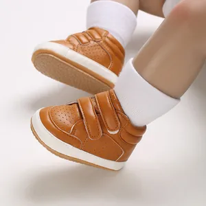 Close-up of tan faux leather baby sneakers with double velcro straps for infants