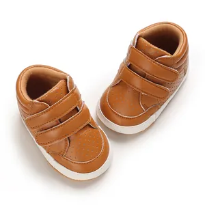 Top-down view of brown leather baby boy walking shoes with hook-and-loop straps