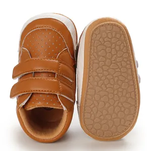 Detailed close-up of brown baby leather walker shoes with textured non-slip soft soles