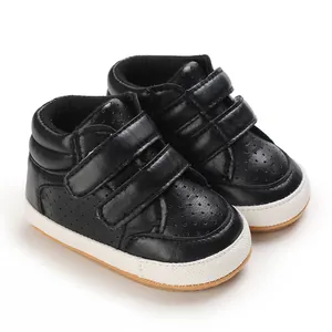 Detailed view of black faux leather infant boy walking shoes featuring velcro straps