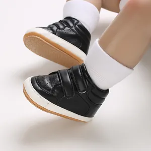 Detailed view of stylish black faux leather baby walking shoes with secure velcro straps