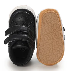Detail view of black baby boy leather walking shoes showing non-slip pebbled sole texture