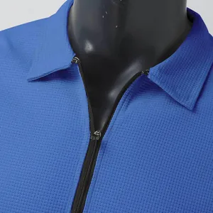 Close-up of a blue men's waffle knit jacket featuring a zipper and polo collar.